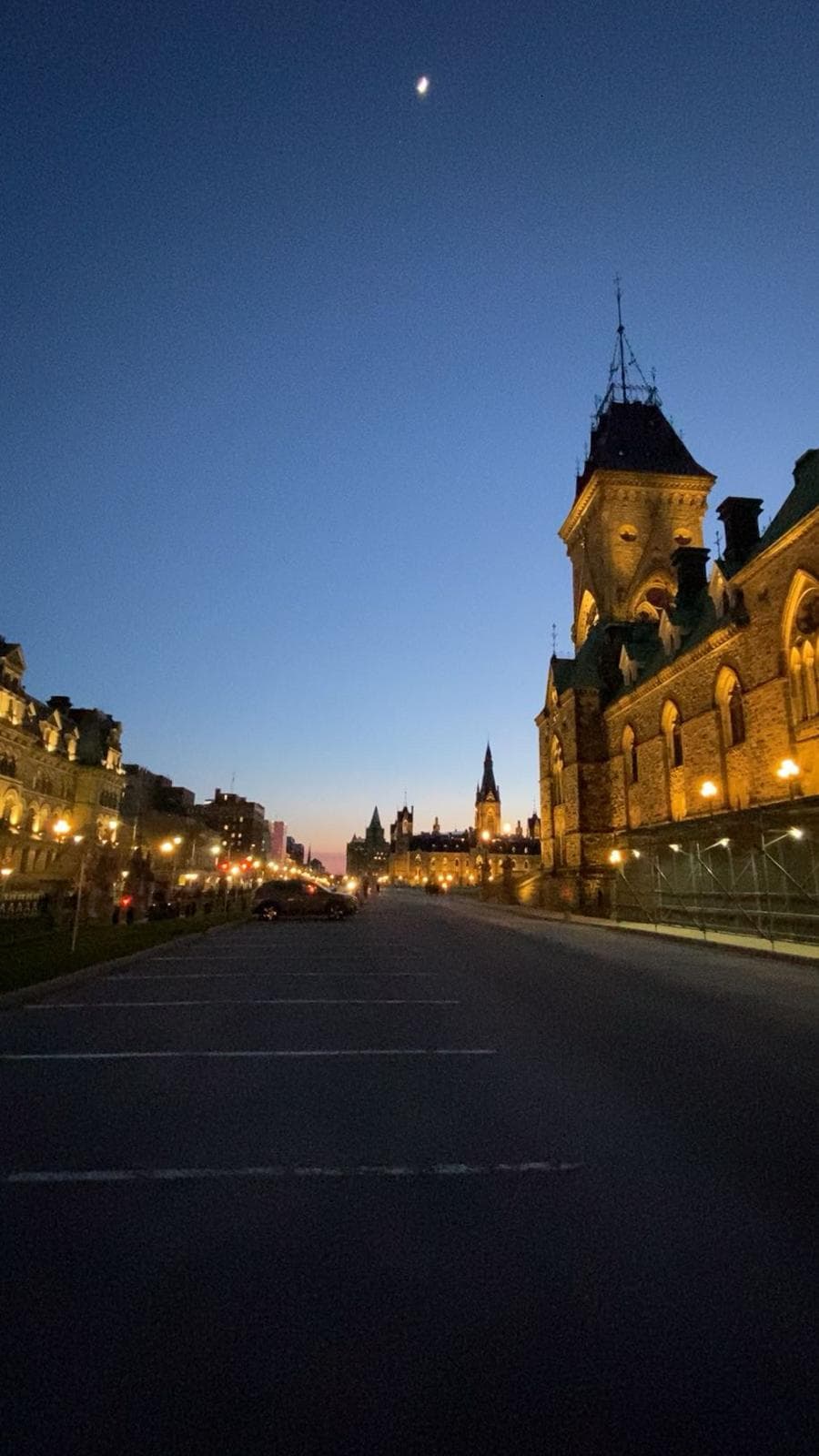 Parliament Hill at dusk with the moon