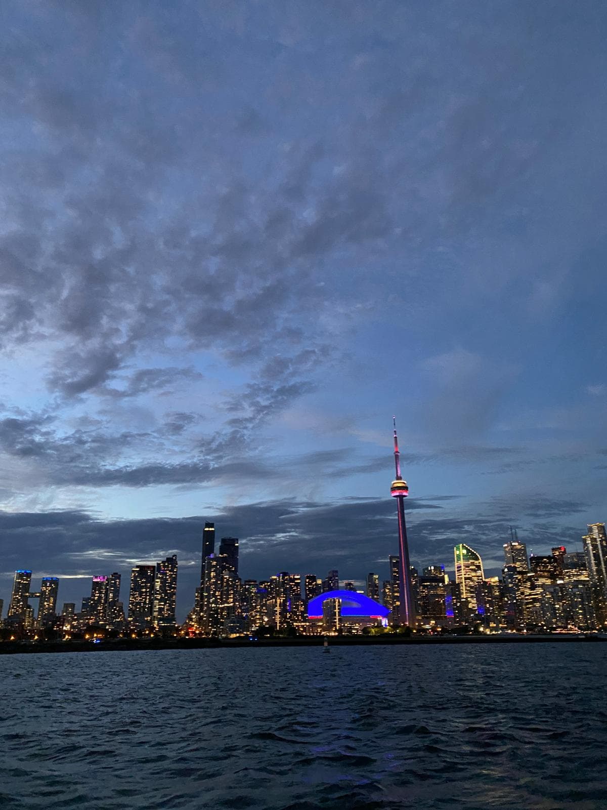 Toronto skyline at night with CN Tower lit