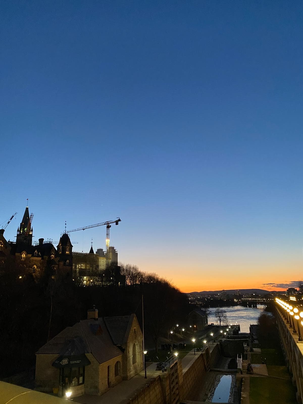 Parliament Hill at sunset over the Rideau Canal